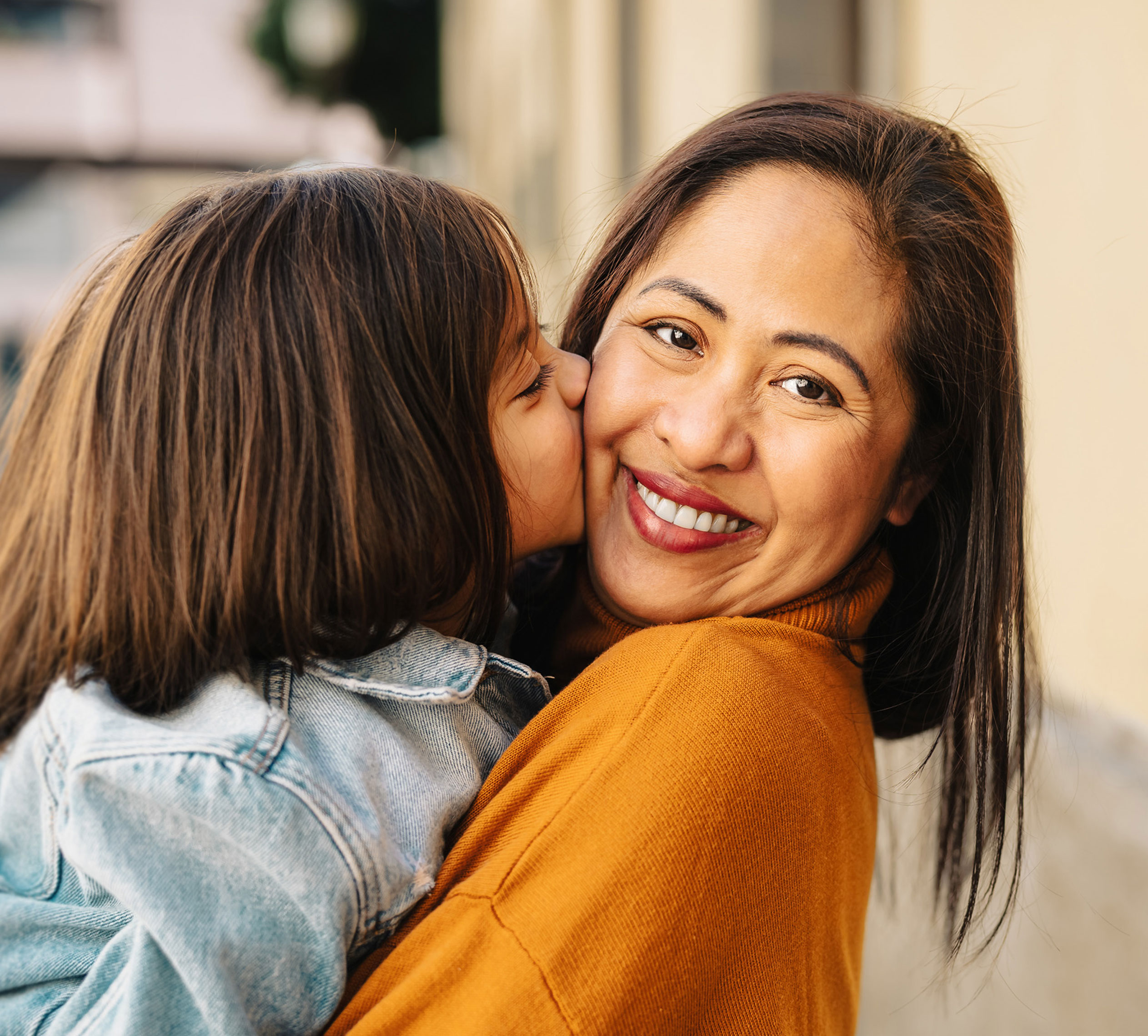 Daughter kissing mom